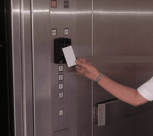 person tapping their condo key fob copy in an elevator